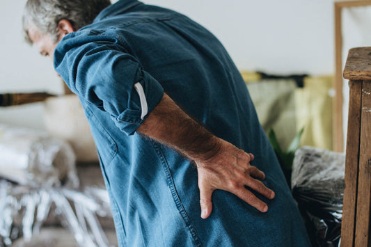 man holding lower back in pain