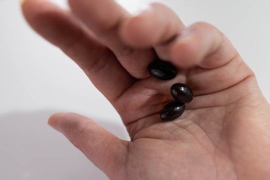 hand holding cbd softgels