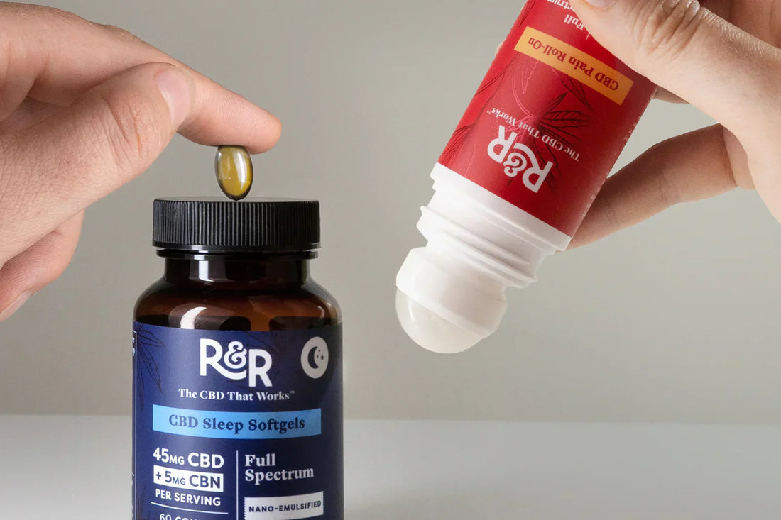 A man holds a softgel above an R&R CBD softgels container while holding a CBD Pain Roll-On in his other hand